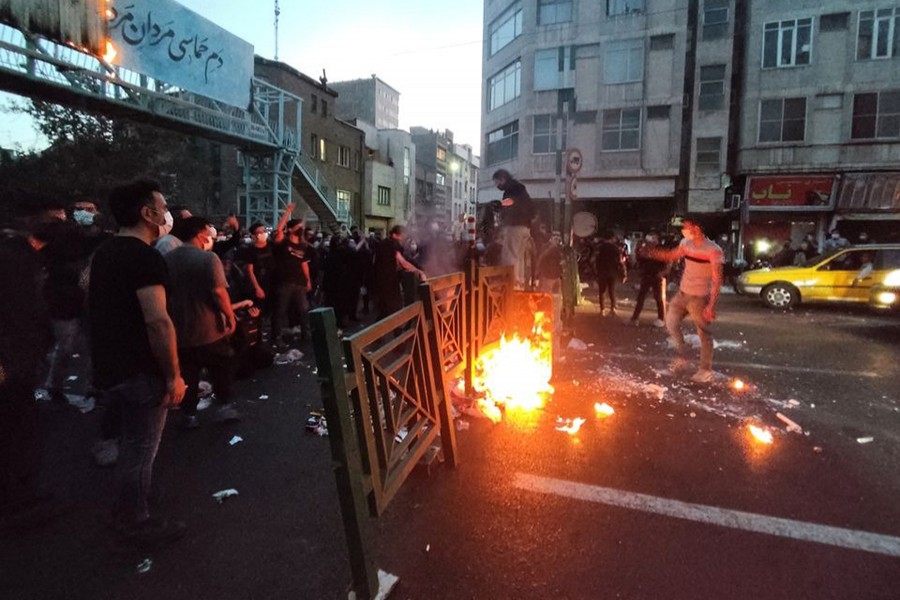 People light a fire during a protest over the death of Mahsa Amini, a woman who died after being arrested by the Islamic republic's "morality police", in Tehran, Iran on September 21, 2022 — — WANA (West Asia News Agency) via REUTERS