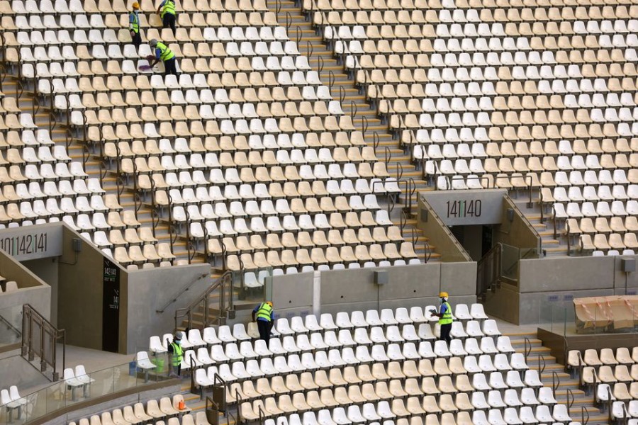Workers clean seats inside the Lusail Stadium, the venue for the 2022 Qatar World Cup Final in Lusail, Qatar on March 28, 2022 — Reuters photo