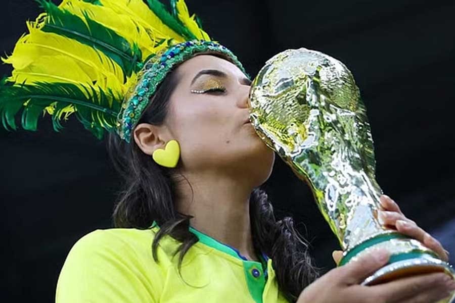 A Brazil fan is pictured with a replica World Cup trophy inside Education City Stadium in Doha before FIFA World Cup Qatar 2022 Quarter Final match between Croatia and Brazil on Friday –Reuters photo