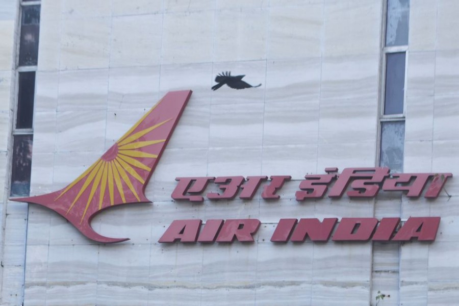 A bird flies over a logo of Air India airlines at the corporate headquarters in Mumbai, India, October 19, 2021. REUTERS/Francis Mascarenhas