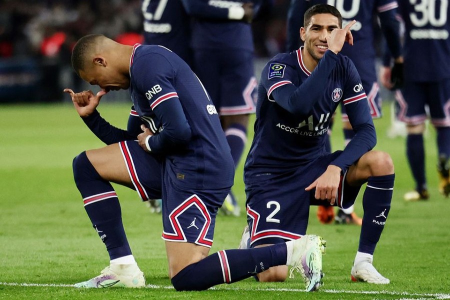 Paris St Germain's Kylian Mbappe celebrates with teammate Achraf Hakimi after scoring their second goal against Lorient Parc des Princes, Paris, France on April 3, 2022