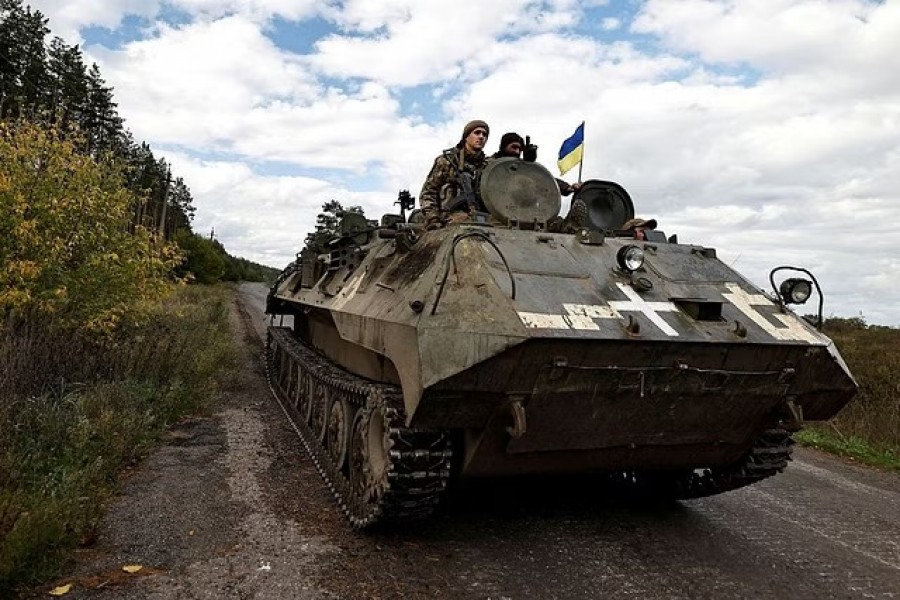 Ukrainians ride an armoured vehicle, amid Russia's attack on Ukraine, in Donesk region, Ukraine, Oct 3 2022. REUTERS