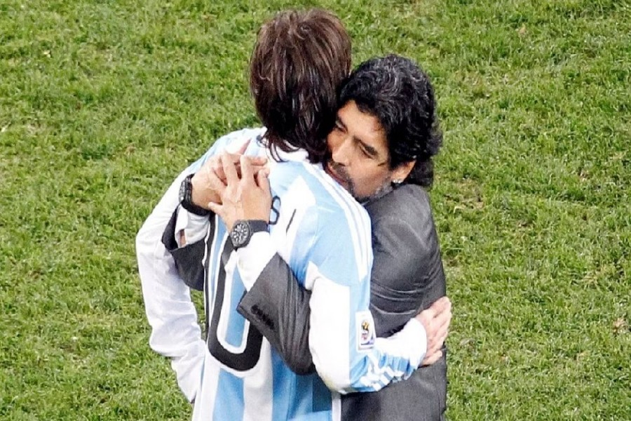 FILE PHOTO: Argentina's coach Diego Maradona hugs Argentina's Lionel Messi after their 2010 World Cup quarter-final football match against Germany at Green Point stadium in Cape Town, July 3, 2010. REUTERS