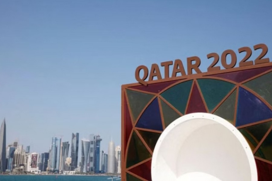 2022 World Cup - Doha, Qatar - November 10, 2022 A Qatar 2022 logo is seen in front of the skyline of the West Bay in Doha REUTERS/John Sibley