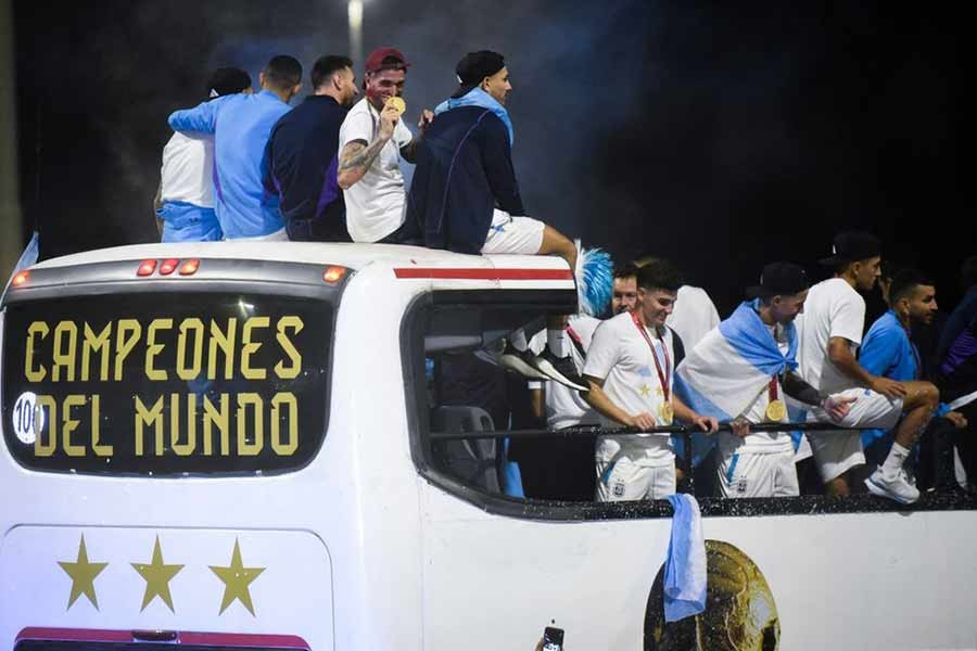 FIFA World Cup winning country Argentina's Rodrigo De Paul, Leandro Paredes, Lionel Messi and Julian Alvarez are seen on the open top bus as it arrives outside the Association of Argentinian Football Headquarters on Tuesday –Reuters photo