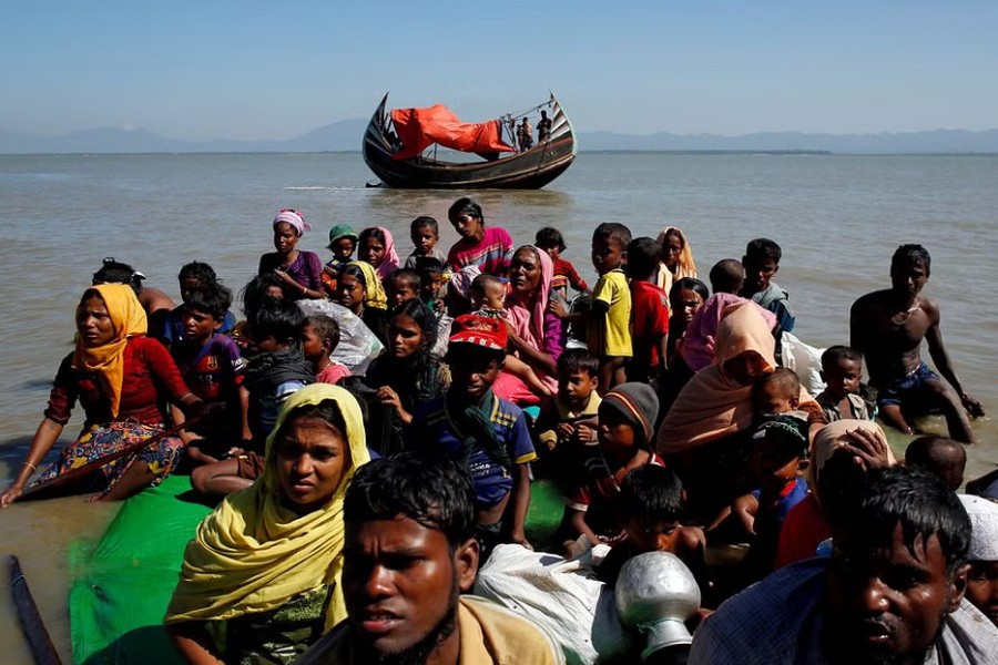 Rohingya refugees sit on a makeshift boat as they get interrogated by the Border Guard Bangladesh after crossing the Bangladesh-Myanmar border, at Shah Porir Dwip near Cox's Bazar, Bangladesh Nov 9, 2017. REUTERS