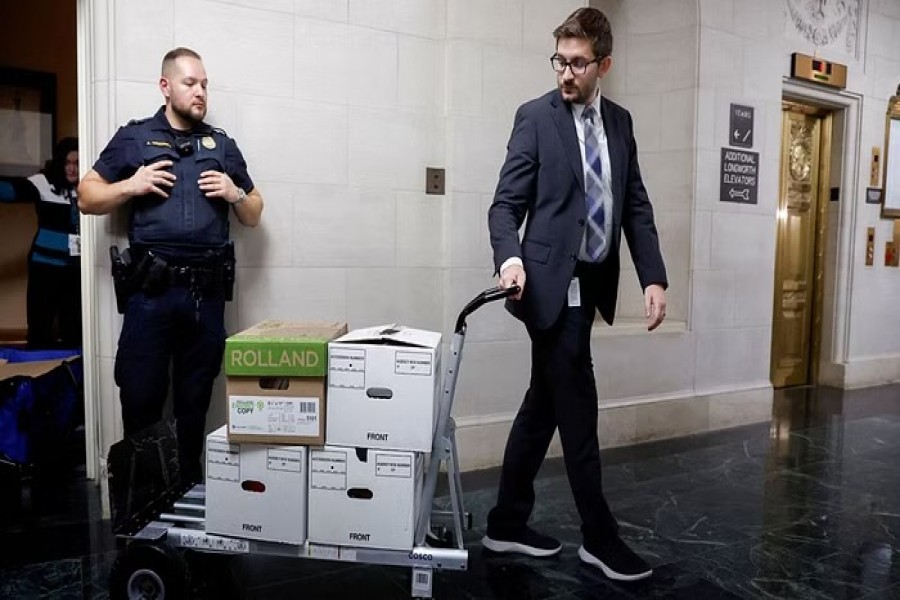 US House Ways and Means Committee staff members transport boxes of documents after a committee meeting to discuss former President Donald Trump's tax returns on Capitol Hill in Washington, US, December 20, 2022. REUTERS