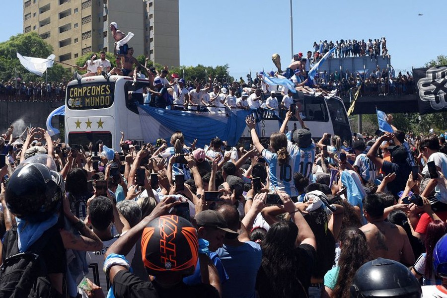 Argentina fans celebrate as the the bus carrying the players and the World Cup trophy is seen during the victory parade in Buenos Aires, Argentina on December 20, 2022 — Reuters photo