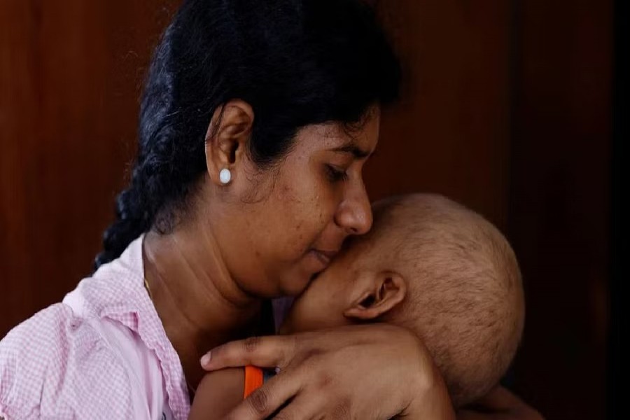 Sathiyaraj Silaksana, 27, holds her son S Saksan, 5, who has been diagnosed with leukaemia, at a cancer care transit home near Apeksha Hospital, Colombo, Sri Lanka, Aug 12, 2022. "Due to the current crisis in Sri Lanka, we are facing severe problems in transport and food," said Silaksana, "I have no option but to pay for my son's needs. My husband, is a construction worker. In order to pay for all these expenses we pawned our jewellery." REUTERS