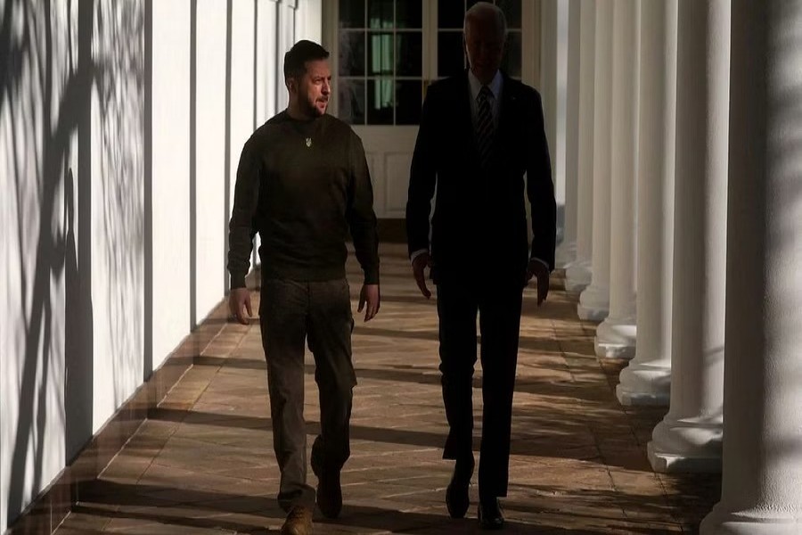 US President Joe Biden and Ukraine's President Volodymyr Zelensky walk down the Colonnade to the Oval Office at the White House in Washington, US, Dec 21, 2022. REUTERS