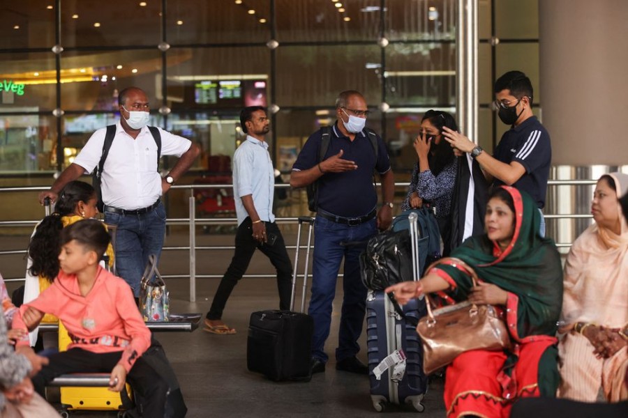 Passengers wait with their luggage at the Chhatrapati Shivaji Maharaj International Airport in Mumbai, India on December 22, 2022 — Reuters photo