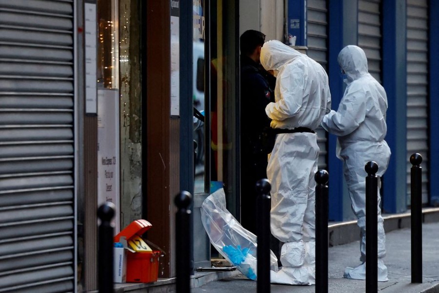 French scientific police work on Rue d'Enghien after gunshots were fired, killing and injuring several people, in a central district of Paris, France, December 23, 2022. REUTERS/Sarah Meyssonnier/File Photo
