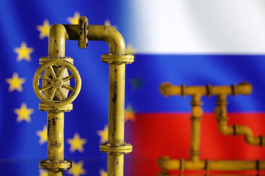 Model of natural gas pipeline, EU and Russia flags on July 18, 2022 — Reuters illustration/Files