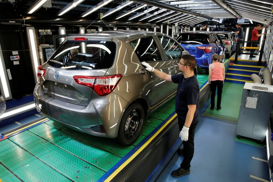 A Toyota Motor Corp. worker inspects a Yaris on the production line of the company's plant in Onnaing, near Valenciennes, France, May 17, 2017. REUTERS/Benoit Tessier/File Photo