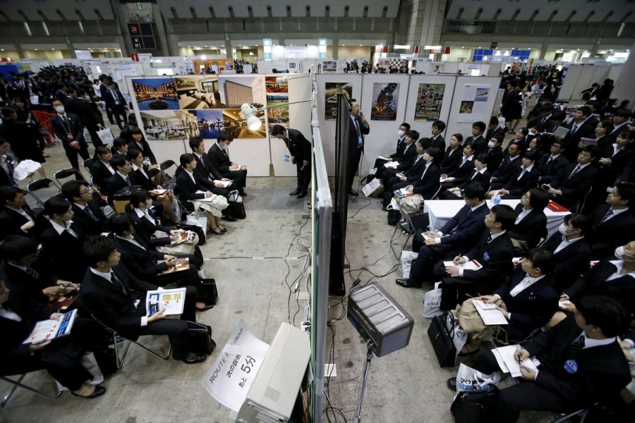 Job seekers attend orientation sessions at company booths during a job fair held for fresh graduates in Tokyo, Japan, March 20, 2016. REUTERS/Yuya Shino/File Photo