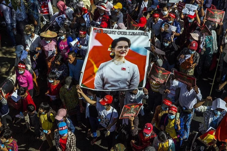 Anti-coup protesters carry a portrait of Aung San Suu Kyi, the deposed civilian leader, during a march in Yangon, Myanmar on Feb 13, 2021. When a court in Myanmar on Monday, Dec 6, 2021, sentenced Suu Kyi to four years in custody, it closed a chapter on an era of weak and compromised democracy in a Southeast Asian nation long ruled by a military fist.The New York Times