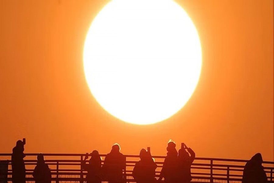 People take photographs of the first sunrise of the year at a park in Seoul, South Korea, Jan 1, 2023. REUTERS