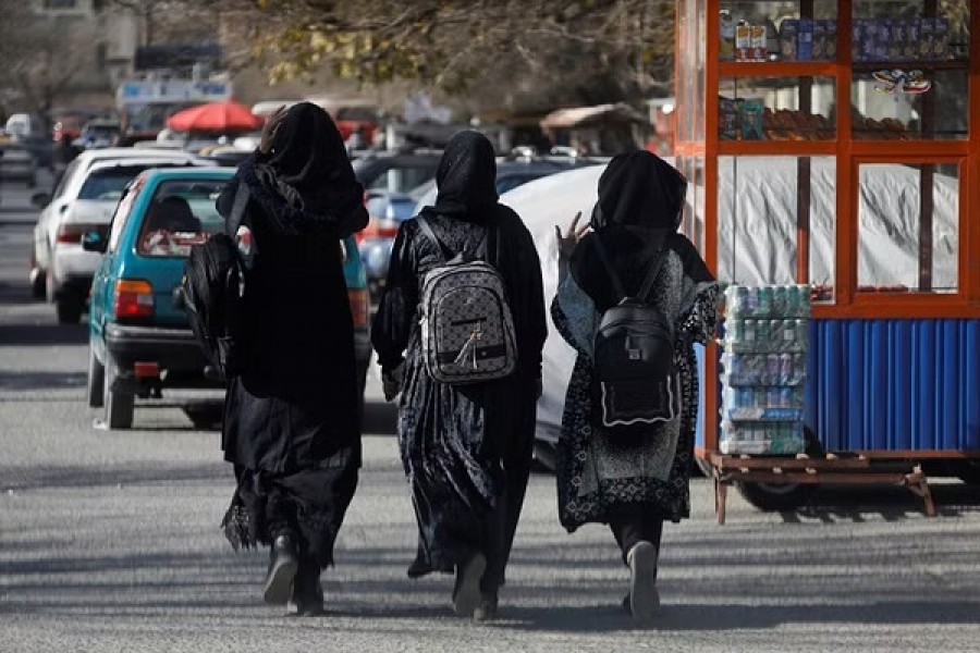 Afghan female students walk near Kabul University in Kabul, Afghanistan, Dec 21, 2022.REUTERS