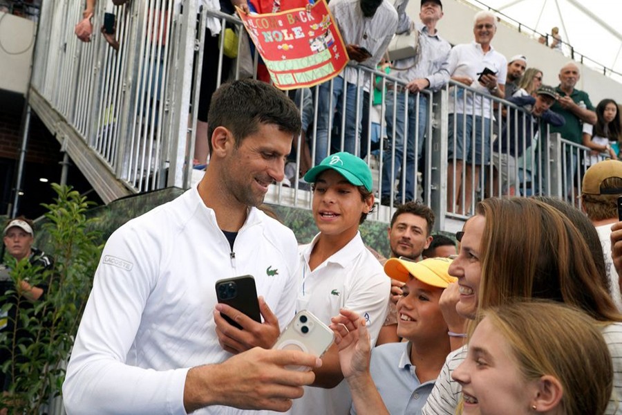 Serbia's Novak Djokovic with fans after winning his first round match of Adelaide International against France's Constant Lestienne at Memorial Drive Tennis Club in Adelaide, Australia on January 3, 2023 — Reuters photo