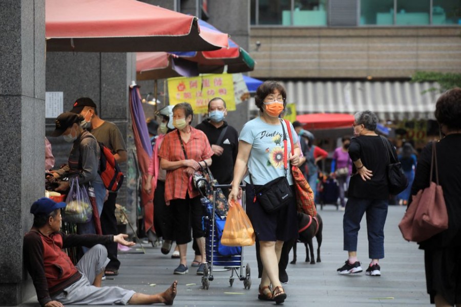 People wearing face masks as precaution against the coronavirus disease (COVID-19) shop at a market in Keelung, Taiwan April 28, 2022. REUTERS/I-Hwa Cheng