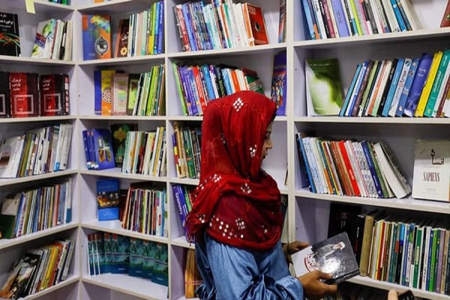 An Afghan woman attends the inauguration of women's library in Kabul, Afghanistan, August 24, 2022. REUTERS/Ali Khara