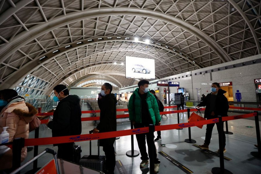 Travellers queue to board a plane at Chengdu Shuangliu International Airport amid a wave of the coronavirus disease (Covid-19) infections, in Chengdu, Sichuan province, China on December 30, 2022 — Reuters/Files