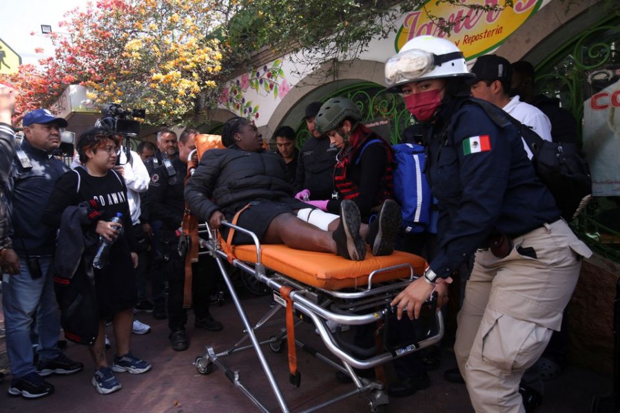 Paramedics assist a woman after two subway trains collide head-on at a subway station, in Mexico City, Mexico, January 7, 2023. REUTERS/Quetzalli Nicte-Ha