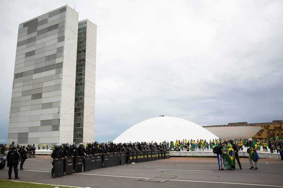 Police blocking supporters of Brazil's far-right former President Jair Bolsonaro who dispute the election of leftist President Luiz Inacio Lula da Silva outside Brazil's Congress after protesters had invaded the building as well as the presidential palace and Supreme Court in Brasilia on Sunday -Reuters photo