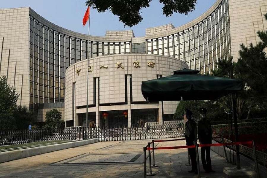 Paramilitary police officers stand guard in front of the headquarters of the People's Bank of China, the central bank (PBOC), in Beijing, China, Sept 30, 2022. REUTERS