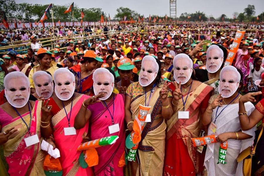 Supporter of India's ruling Bharatiya Janata Party (BJP) wearing masks of Prime Minister Narendra Modi attend an election campaign rally addressed by Modi at Moran town in the northeastern state of Assam, India on March 30, 2019 — Reuters/Files