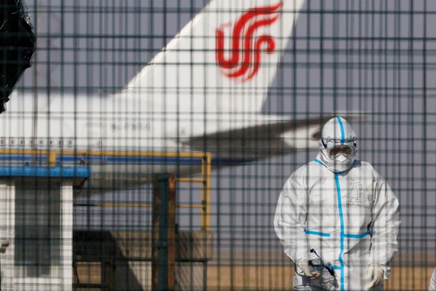 A worker in a protective suit walks near a plane of Air China airlines at Beijing Capital International Airport as coronavirus disease (Covid-19) outbreaks continue in Beijing, China on January 6, 2023 — Reuters/Files