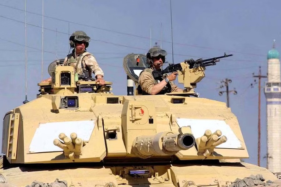 British Sergeant Steve Guy (L) and Corporal Andy Porter keep watch out of a Challenger 2 tank from the 2nd Royal Tank Regiment on patrol in southern Iraq, April 2, 2003. REUTERS