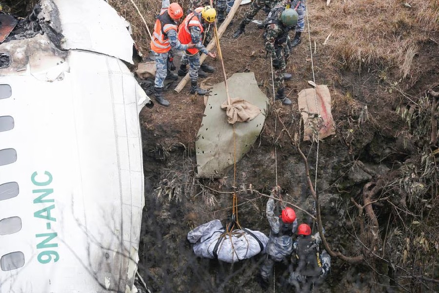 A rescue team recovers the body of a victim from the site of the plane crash of a Yeti Airlines operated aircraft, in Pokhara, Nepal January 16, 2023. REUTERS/Rohit Giri