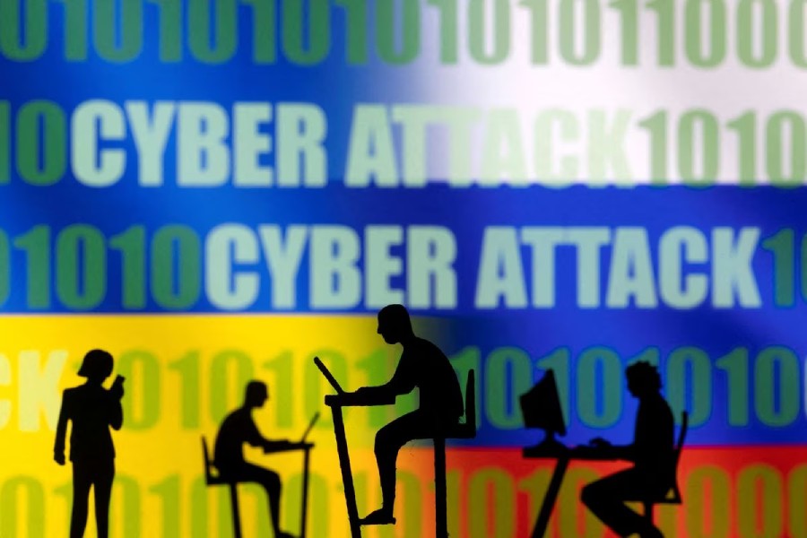 Figurines with computers and smartphones are seen in front of the words "Cyber Attack", binary codes, and Russian and Ukrainian flags, in this illustration taken February 15, 2022. REUTERS/Dado Ruvic/Illustration/File Photo