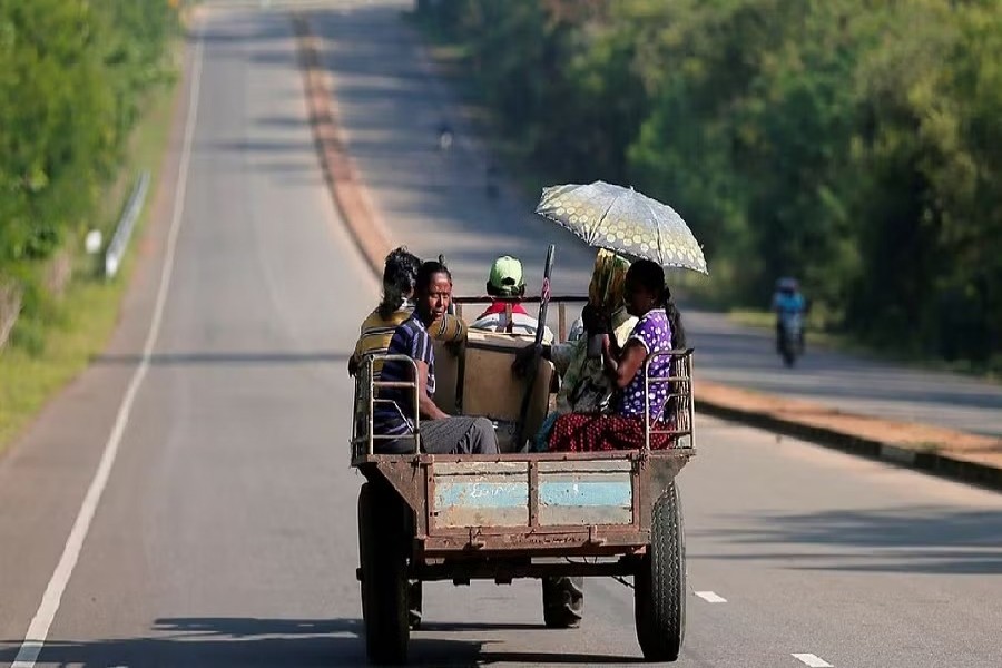 Villagers travel in a tractor on a newly built road in Hambantota, Sri Lanka Mar 24, 2019. REUTERS