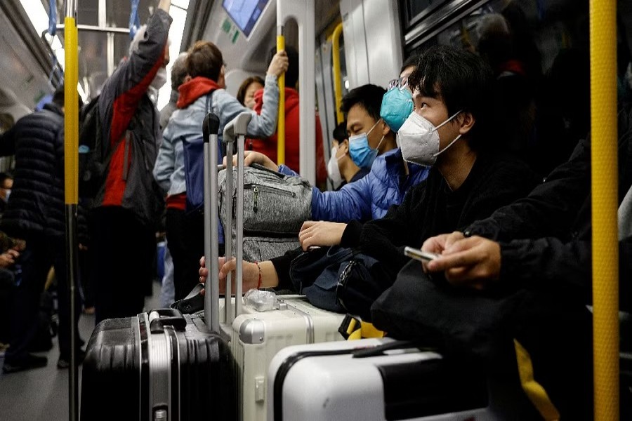 FILE PHOTO: Travellers take the first train to Hong Kong's Lok Ma Chau border checkpoint on the first day China reopens the border amid the coronavirus disease (COVID-19) pandemic in Hong Kong, China, Jan 8, 2023. REUTERS