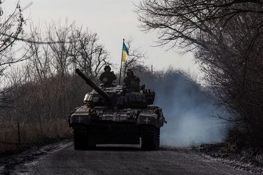 Ukrainian servicemen ride atop a tank near the frontline town of Bakhmut, amid Russia's attack on Ukraine, in Donetsk region, Ukraine Jan 20, 2023. REUTERS