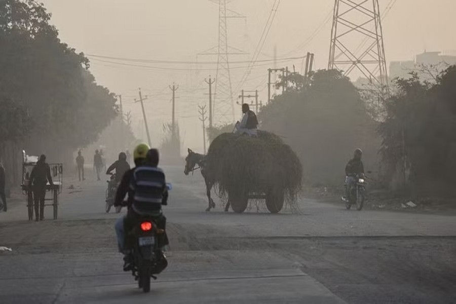 A horse cart crosses a road near dyeing units in Panipat, India, Dec 21, 2022. REUTERS