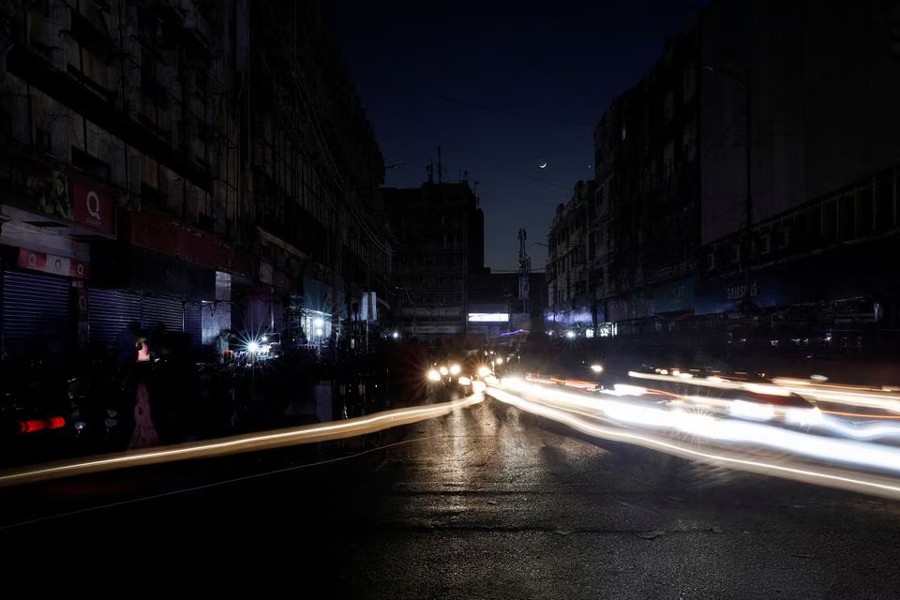 Vehicle lights cause light streaks on the road along a market, during country-wide power breakdown in Karachi, Pakistan on January 23, 2023 — Reuters photo