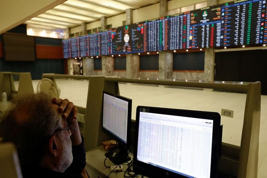 A stock broker monitors the share prices on computers, powered by the generator, in the hall of Pakistan Stock Exchange (PSX) during country-wide power breakdown in Karachi, Pakistan Jan 23, 2023. REUTERS