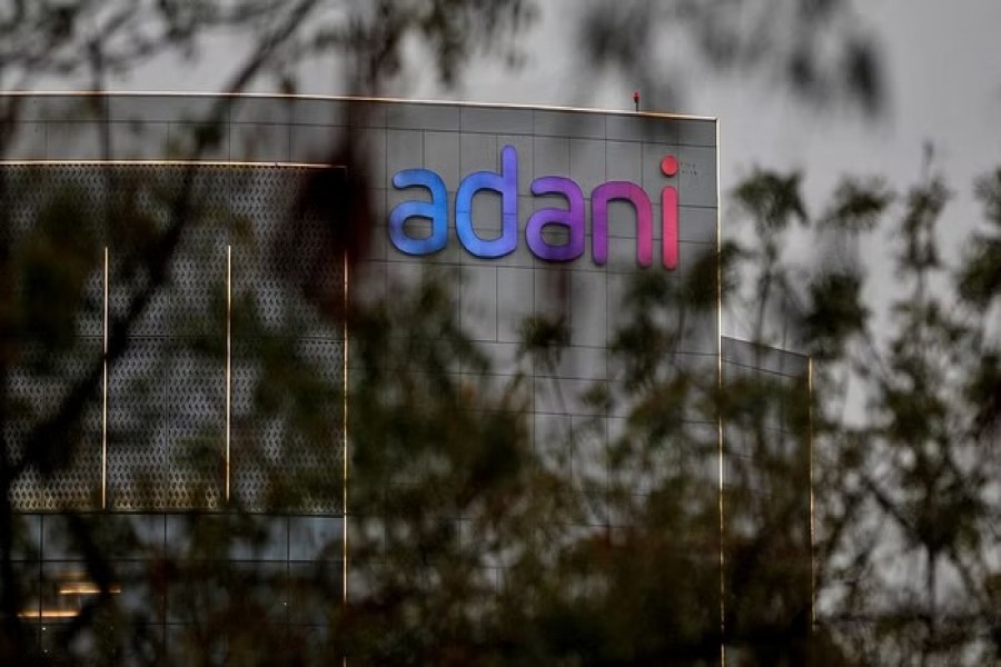 FILE PHOTO: The logo of the Adani Group is seen on the facade of its Corporate House on the outskirts of Ahmedabad, India, Jan 27, 2023. REUTERS/Amit Dave/File Photo