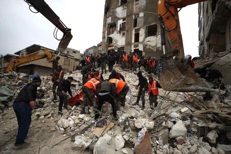 Civil defence workers and security forces searching through the wreckage of collapsed buildings in Hama of Syria on Monday –AP photo