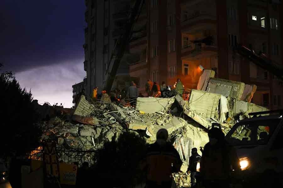 Emergency team members searching for people in a destroyed building in Adana of Turkey on Tuesday –AP photo