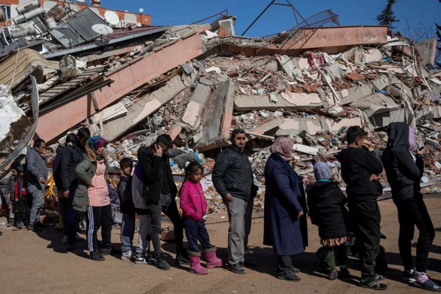 People queue for free food served amid the rubble following the deadly earthquake in Kahramanmaras, Turkey on February 16, 2023 — Reuters photo