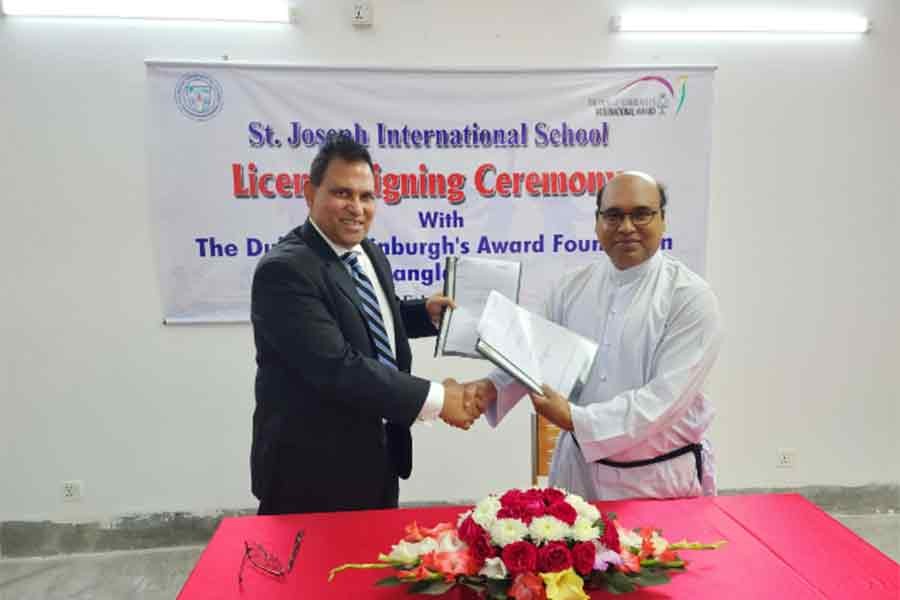 Brother Chandon Benedict Gomes CSC, principal of St. Joseph International School, and Rizwan Bin Farouq, member, Board of Trustees of The Duke of Edinburgh's Award Foundation Bangladesh, exchanging documents after signing an agreement recently