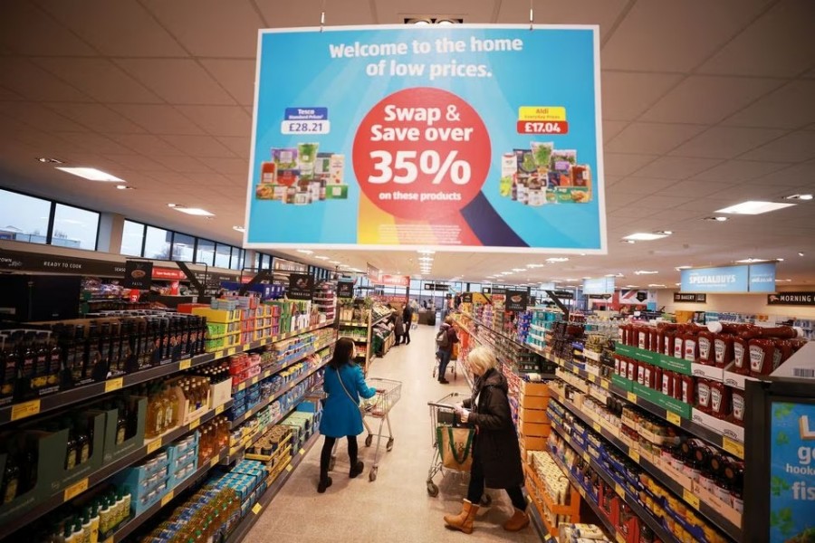 Shoppers push trolleys along an aisle inside an ALDI supermarket near Altrincham, Britain on February 20, 2023 — Reuters photo